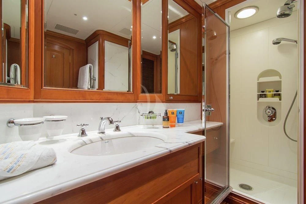 a bathroom with a large mirror aboard XASTERIA Yacht for Charter