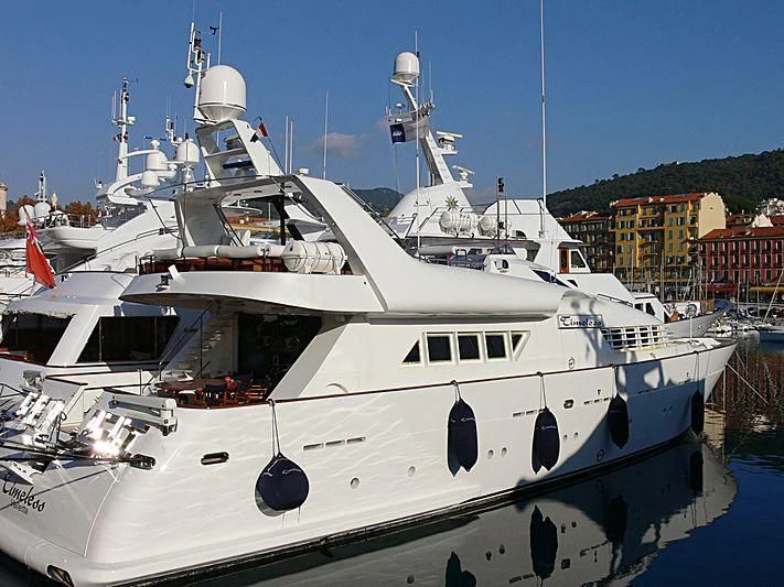 a white yacht in a harbor aboard AN Yacht for Sale