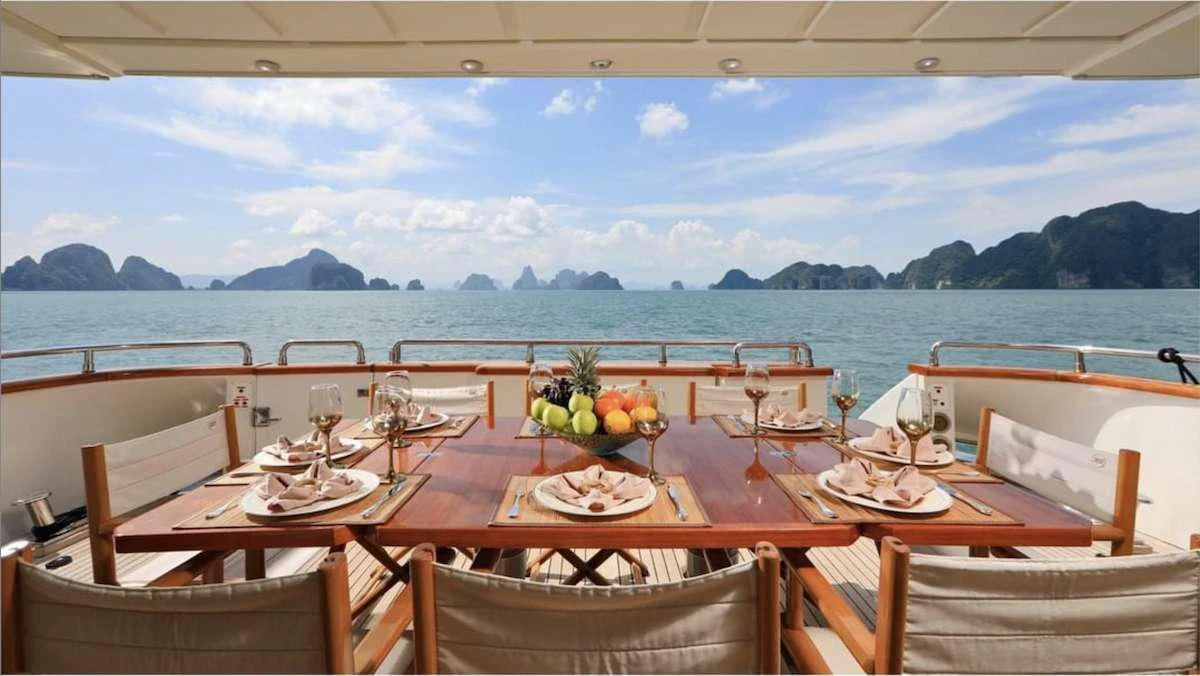 a table set for a meal on a boat aboard DEMAREST Yacht for Sale