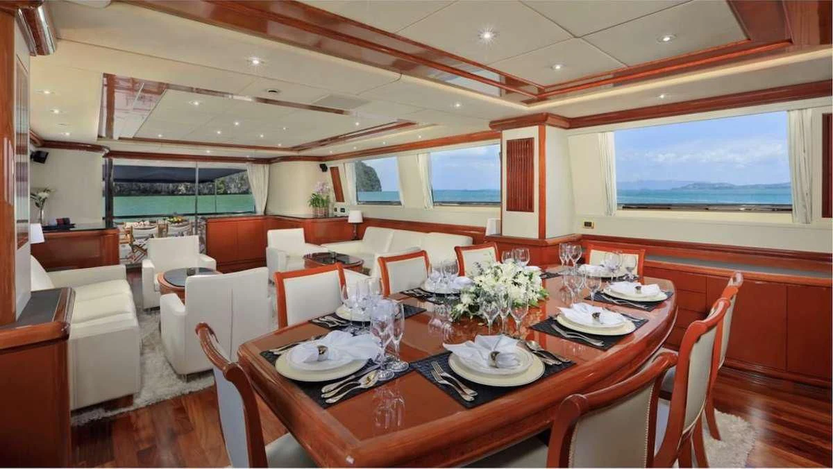 a dining room with tables and chairs aboard DEMAREST Yacht for Sale