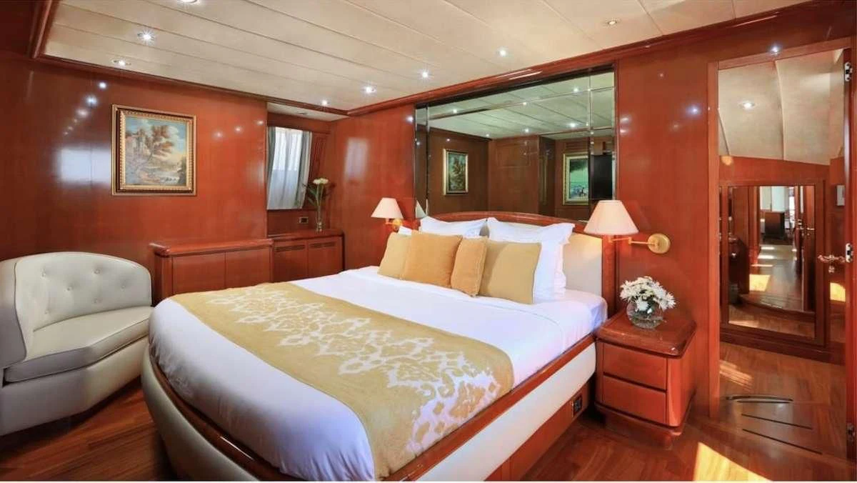 a bedroom with a bed and a couch aboard DEMAREST Yacht for Sale