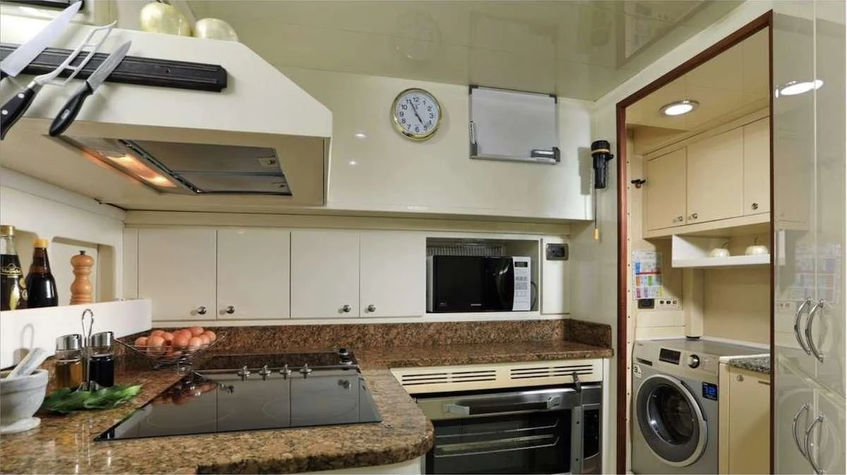 a kitchen with white cabinets aboard DEMAREST Yacht for Sale