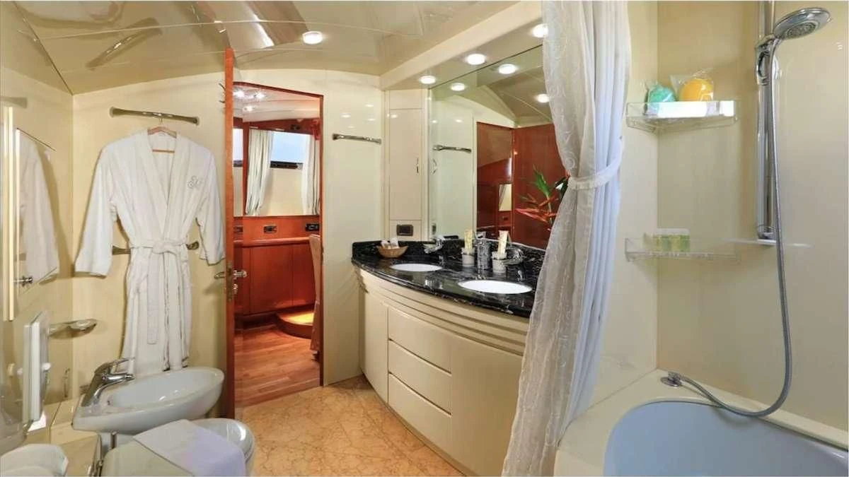 a bathroom with a robe on the wall aboard DEMAREST Yacht for Sale