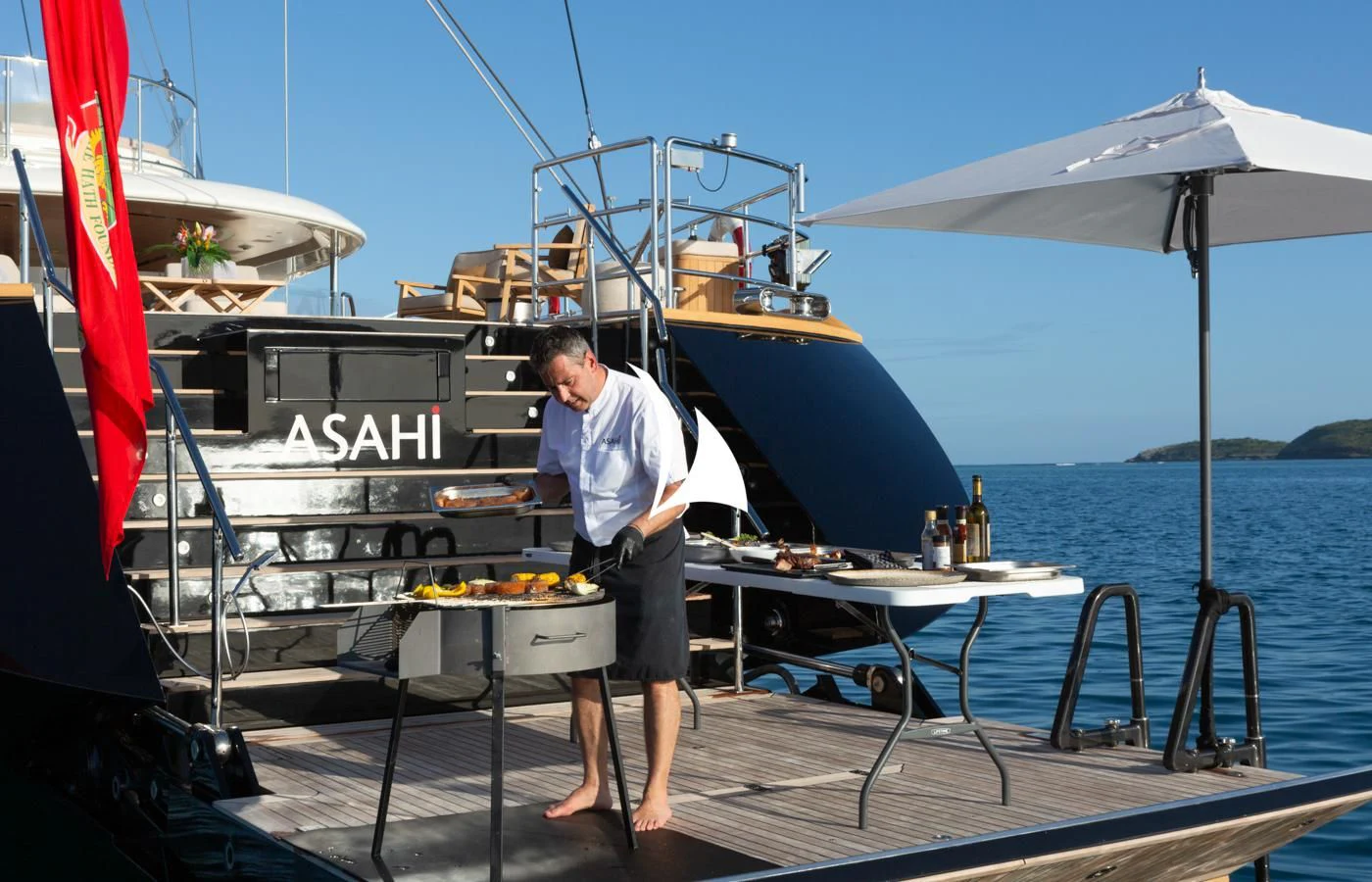 a person grilling food on a boat aboard ASAHI Yacht for Sale