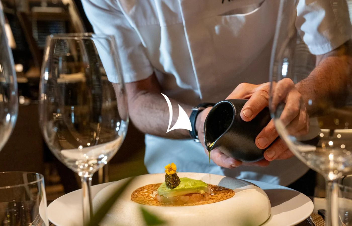 a person pouring wine into a glass aboard ASAHI Yacht for Sale