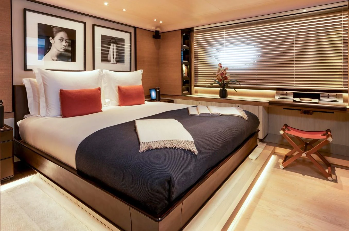a bed with pillows and a chair aboard ASAHI Yacht for Sale
