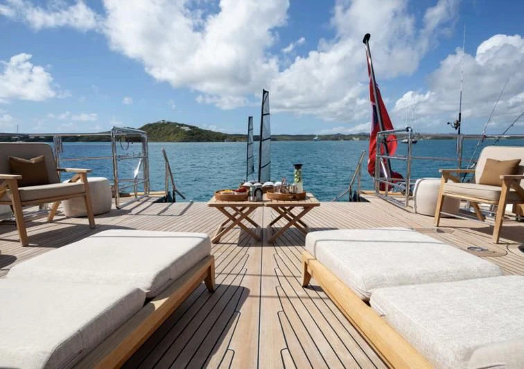 a deck with a view of the water and a boat in the background aboard ASAHI Yacht for Sale