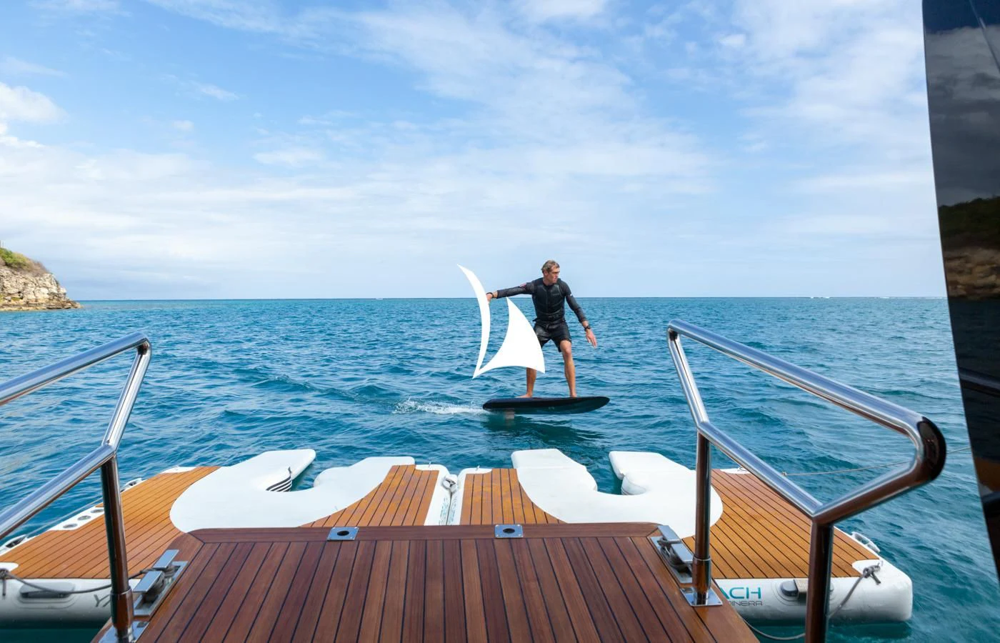a person holding a surfboard on a boat aboard ASAHI Yacht for Sale