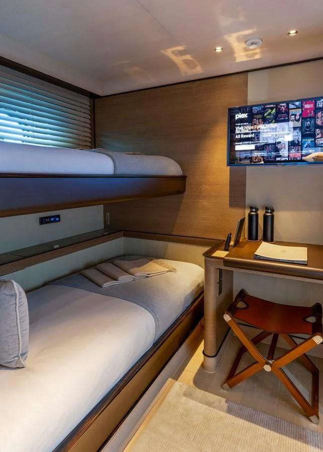 a room with a bed and desk aboard ASAHI Yacht for Sale