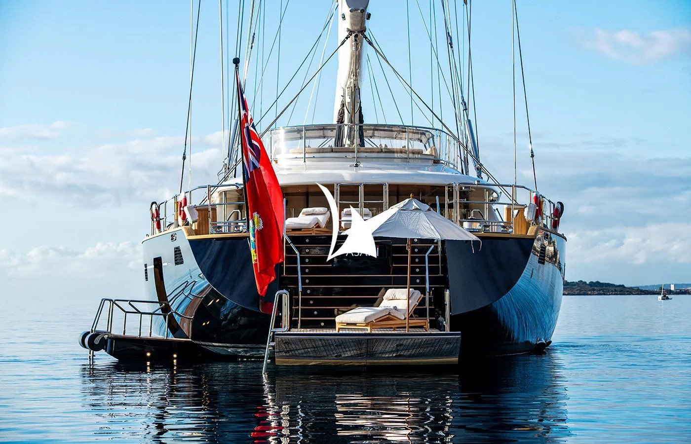 a boat with a flag on it aboard ASAHI Yacht for Sale