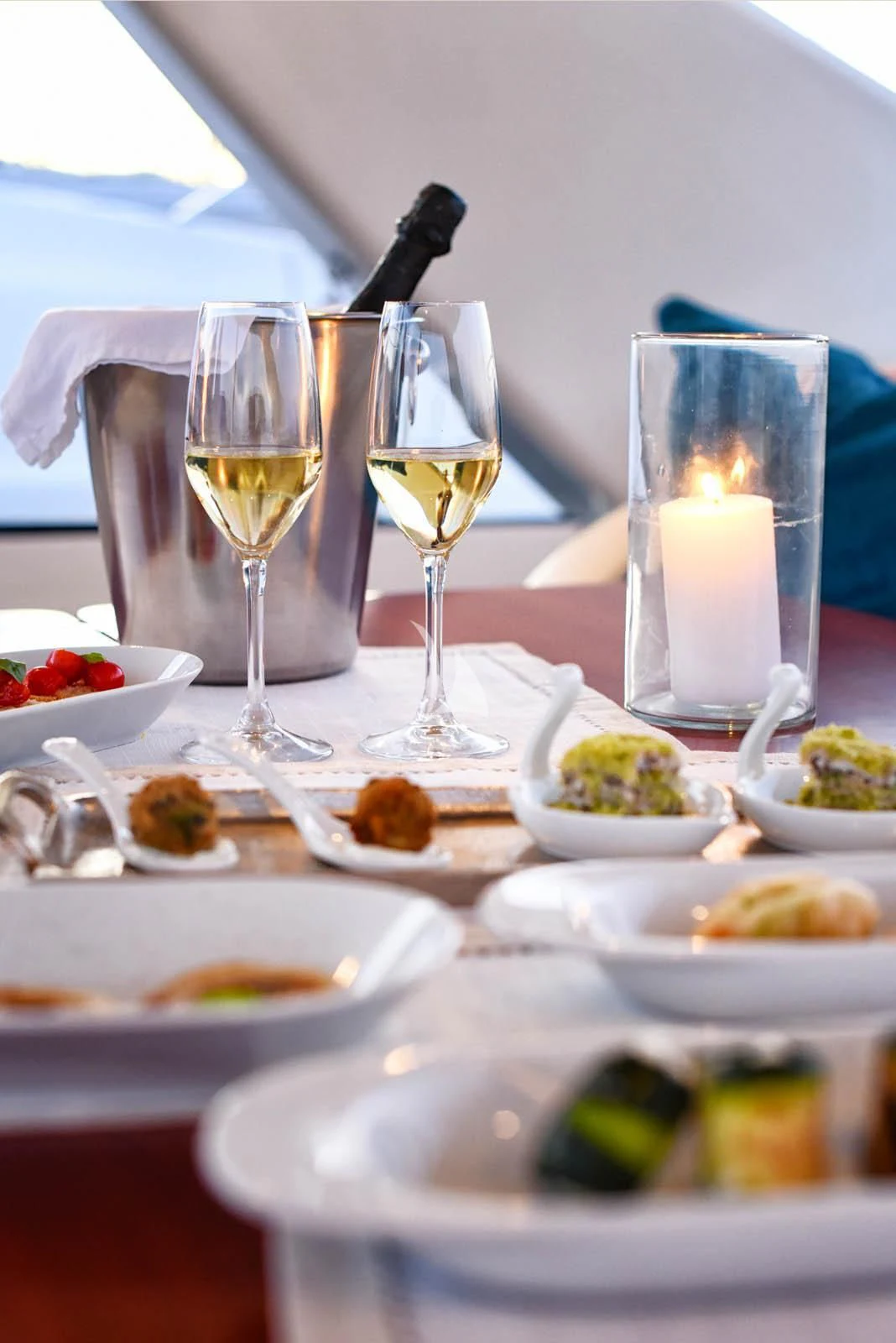 a table with plates of food and glasses of wine aboard ANYTHING GOES IV Yacht for Sale