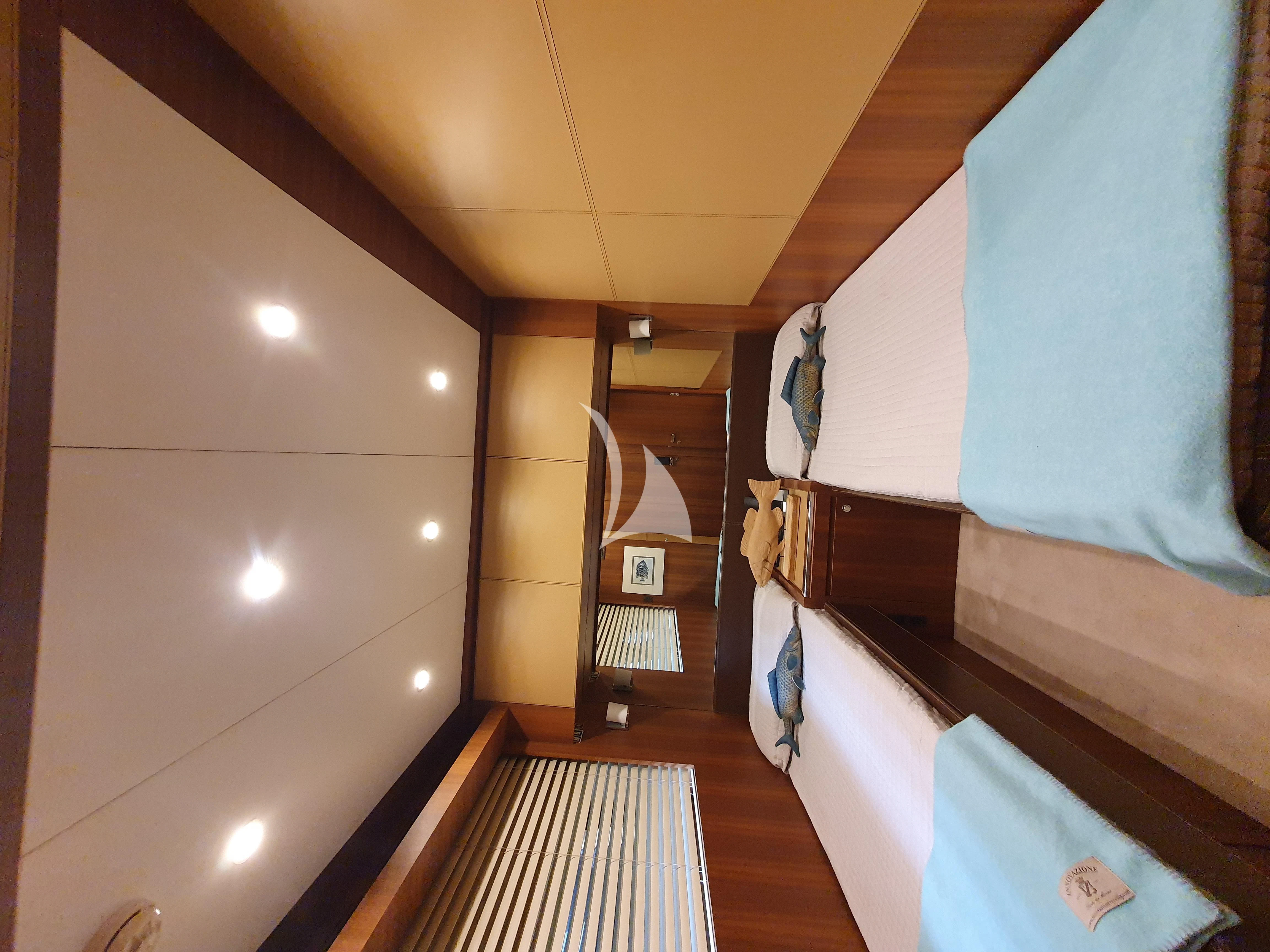 a room with a bed and a desk aboard ANYTHING GOES IV Yacht for Sale