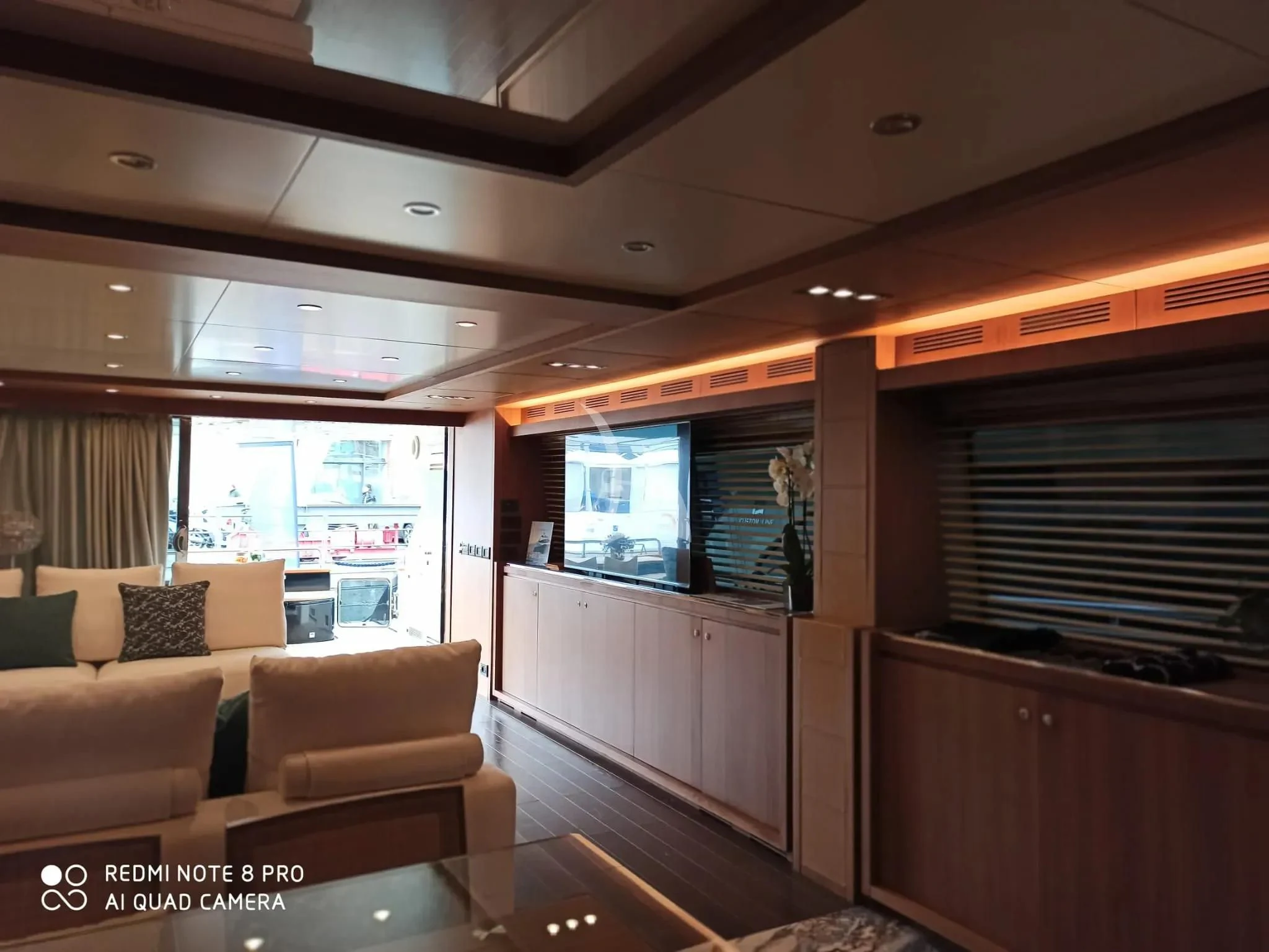 a living room with a couch and a window aboard ANYTHING GOES IV Yacht for Sale