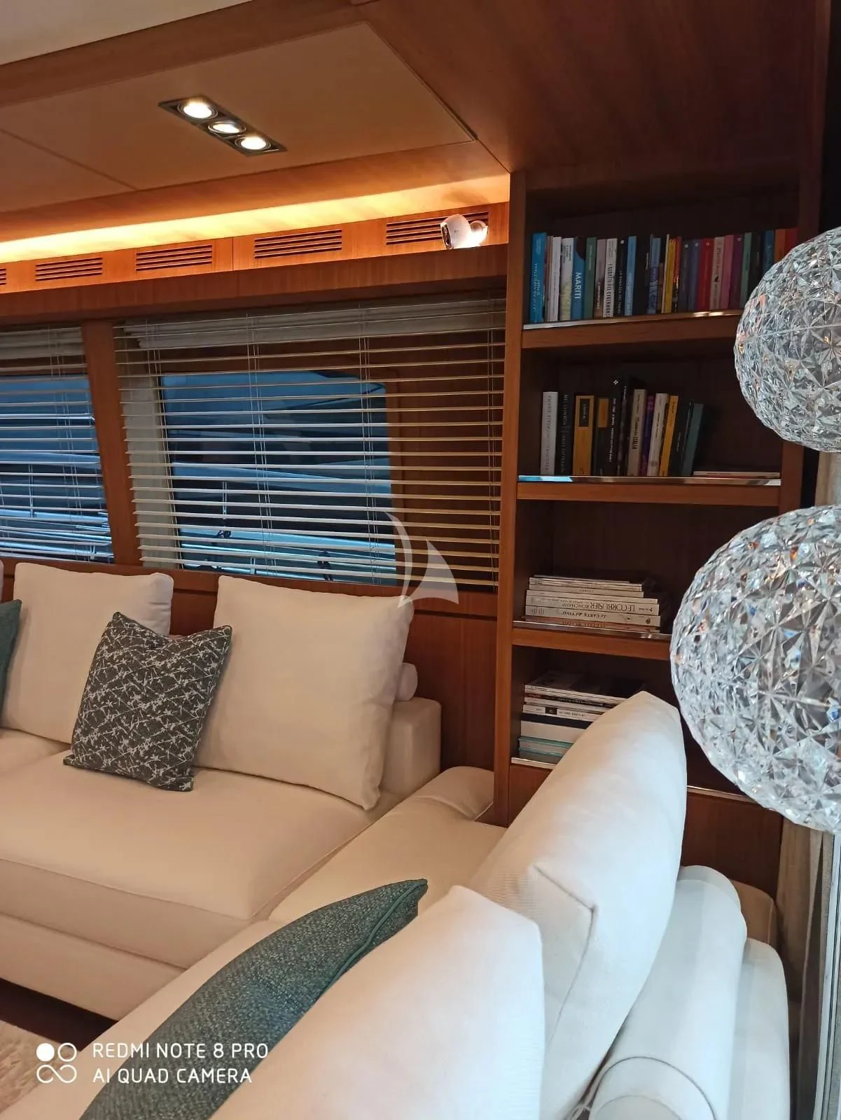 a living room with a bookcase aboard ANYTHING GOES IV Yacht for Sale