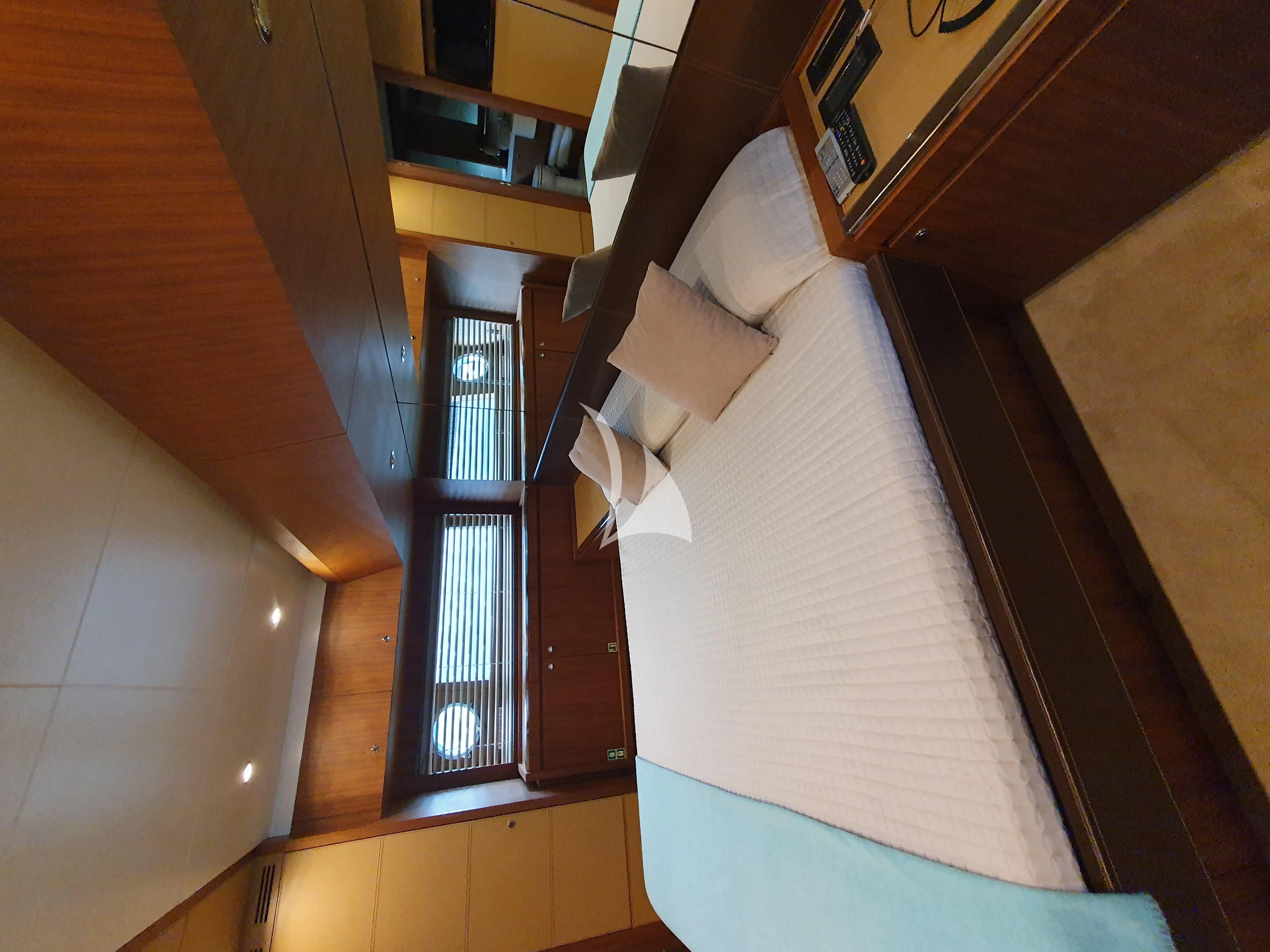 a bed with a striped sheet aboard ANYTHING GOES IV Yacht for Sale
