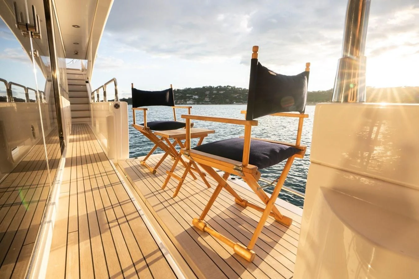 a deck with chairs and a table aboard R2 Yacht for Sale