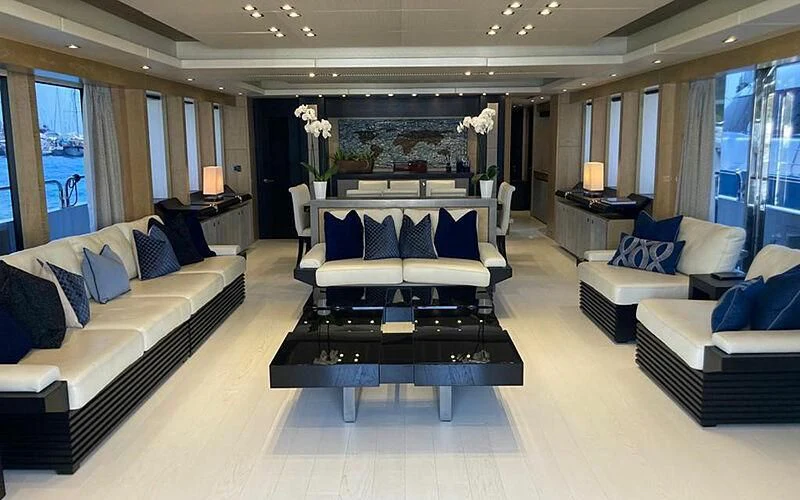 a room with a couch and a table aboard R2 Yacht for Sale