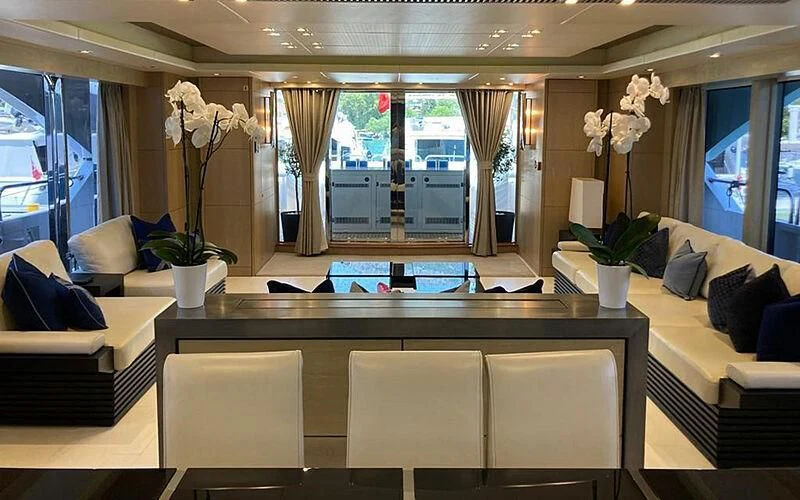a living room with a table and chairs aboard R2 Yacht for Sale