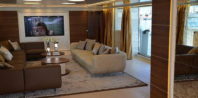 a living room with a large screen aboard LILIYA Yacht for Sale