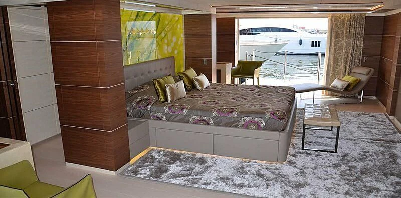 a room with a bed and a table and chairs aboard LILIYA Yacht for Sale