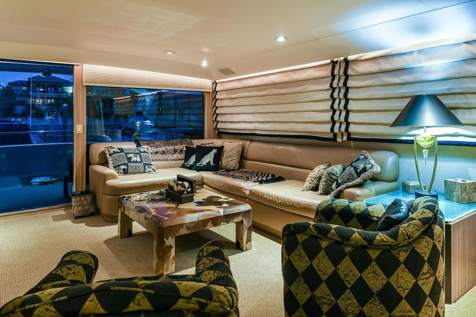 a living room with a couch and a table aboard PRIMETIME III Yacht for Sale