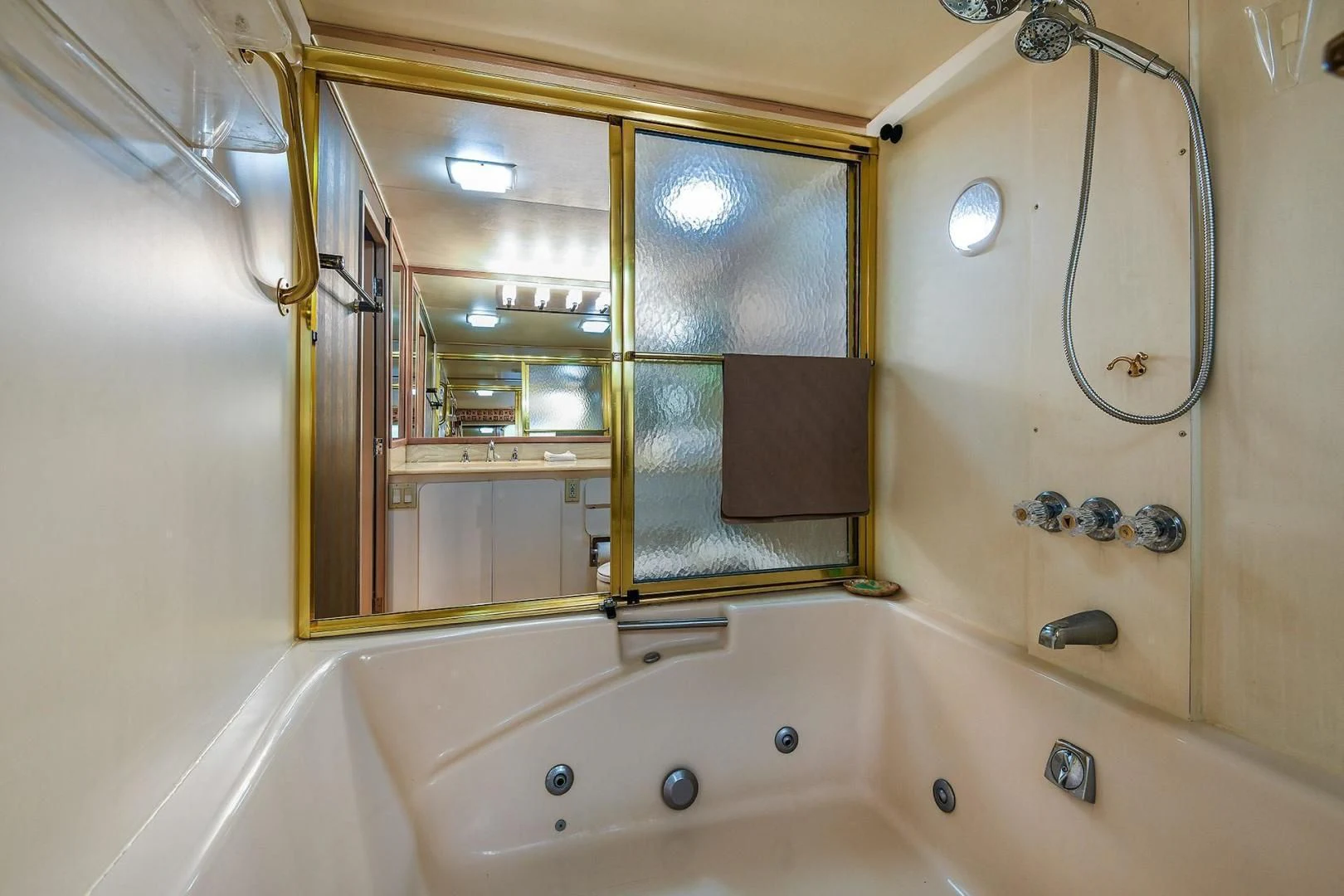 a bathtub with a shower head aboard PRIMETIME III Yacht for Sale