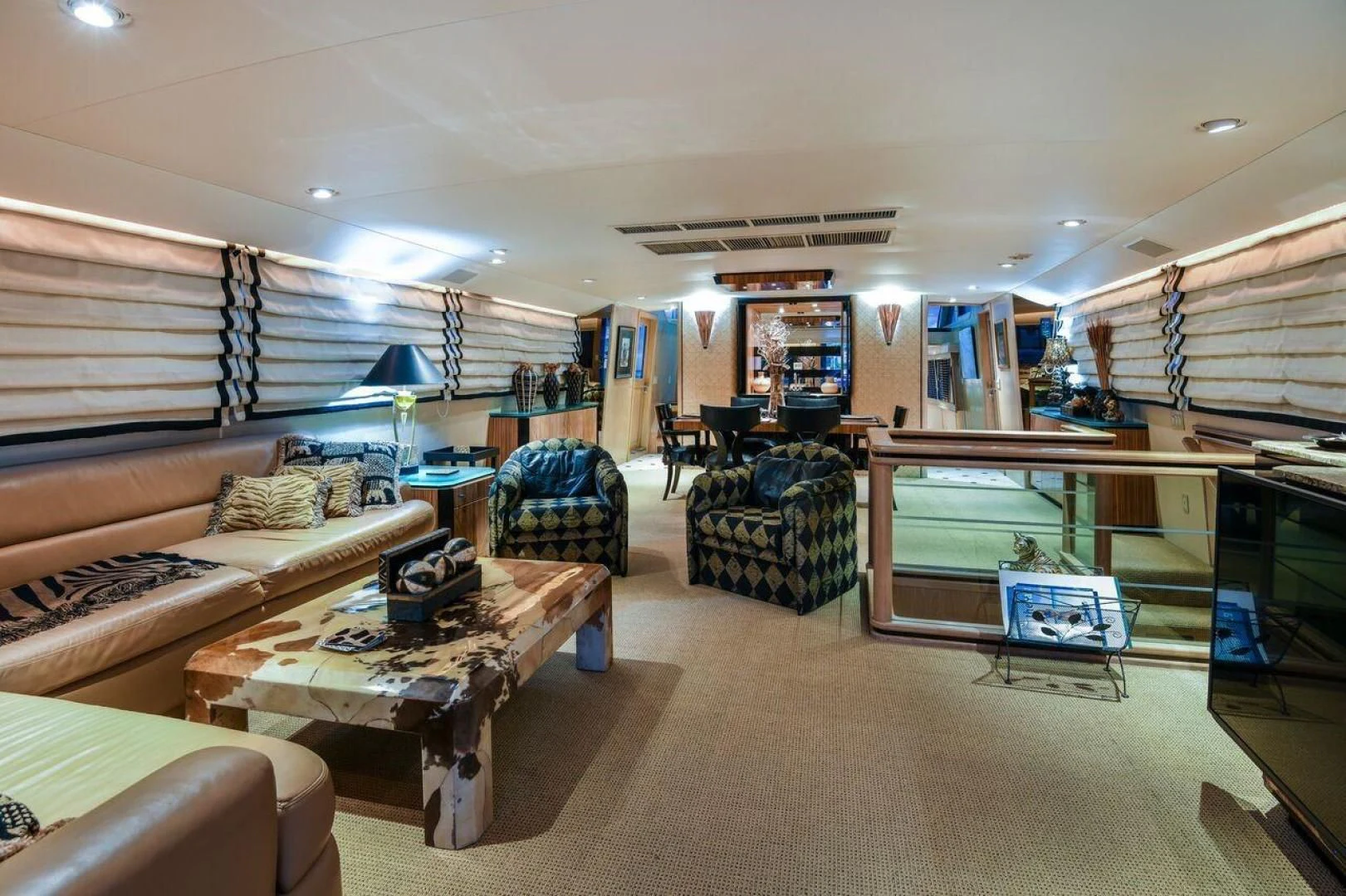 a living room with a couch and a table aboard PRIMETIME III Yacht for Sale