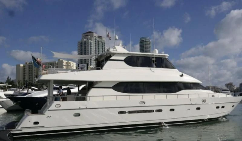 a white yacht in a harbor aboard ELECTRIFIED Yacht for Sale