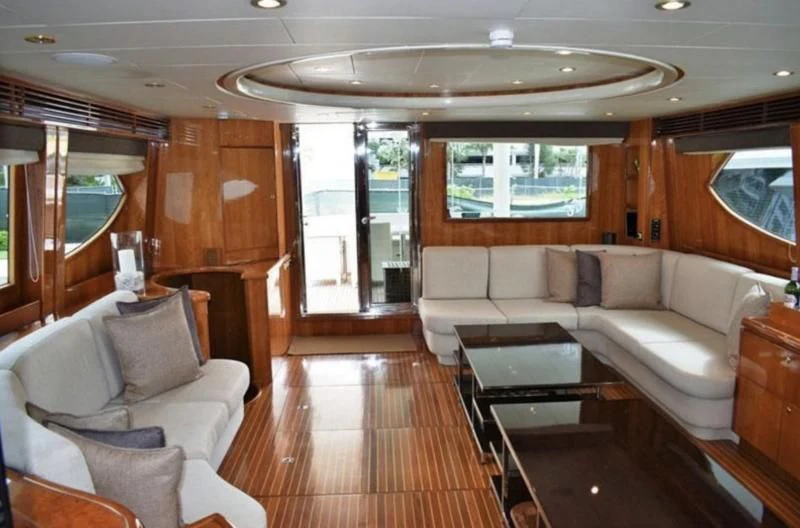 a living room with a wood paneled wall aboard ELECTRIFIED Yacht for Sale