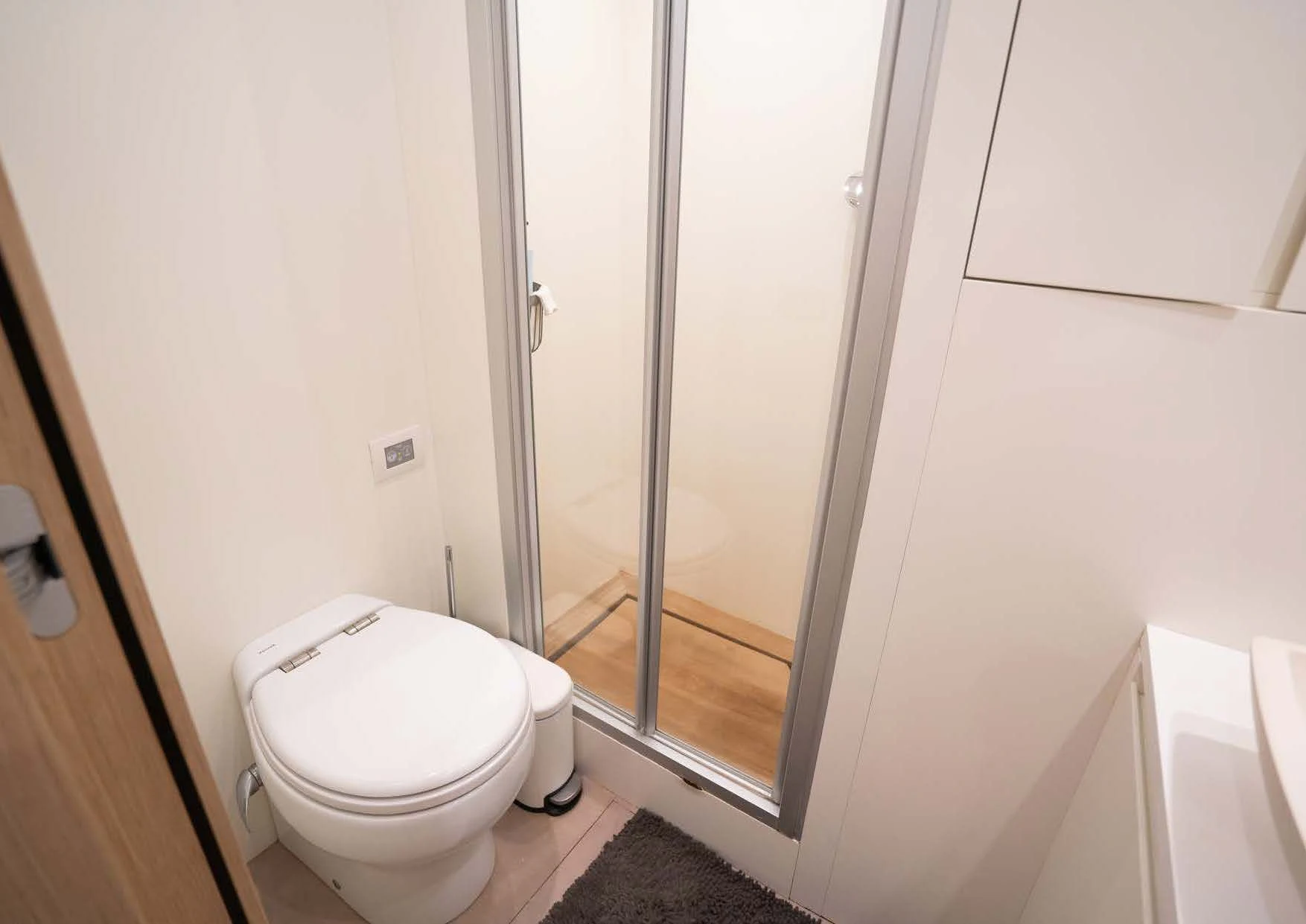 a bathroom with a glass shower aboard ANMAX Yacht for Sale