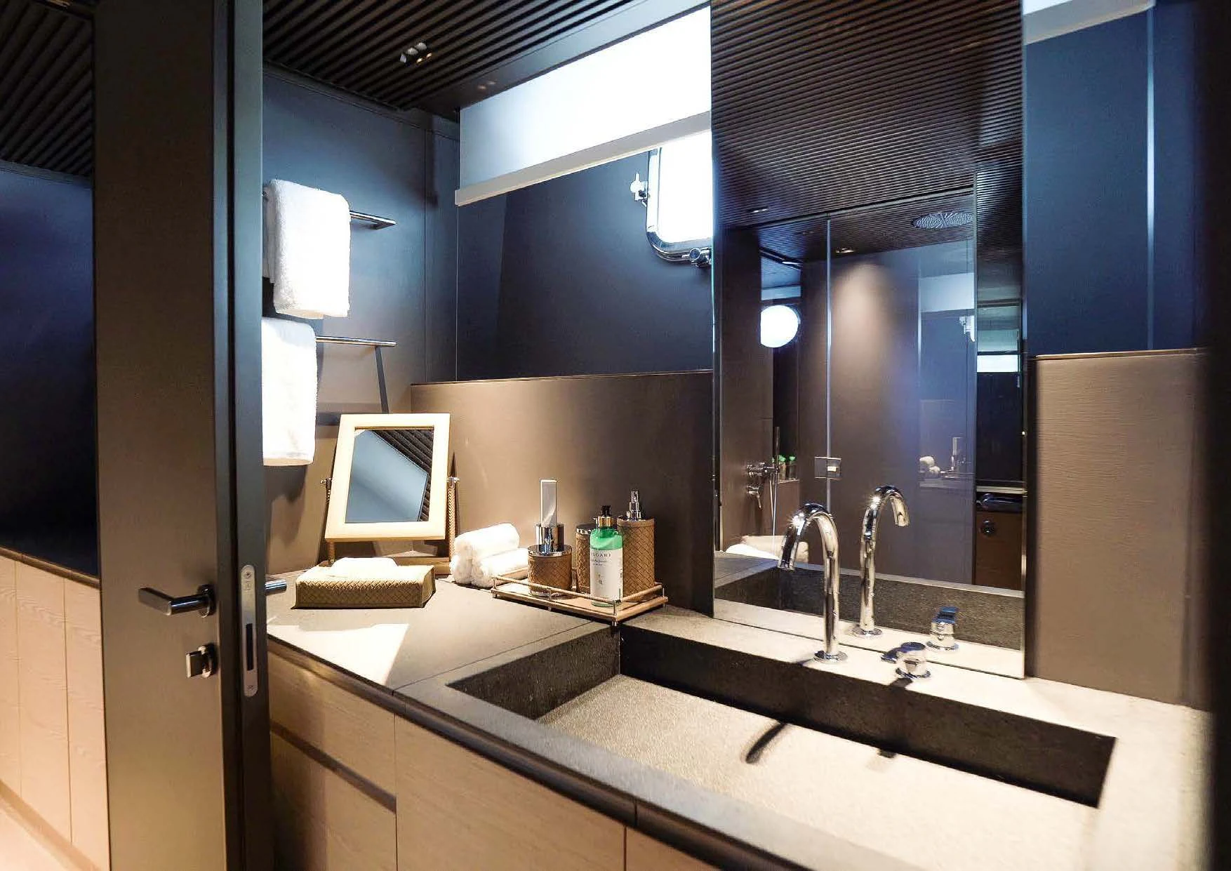 a bathroom with a large mirror aboard ANMAX Yacht for Sale