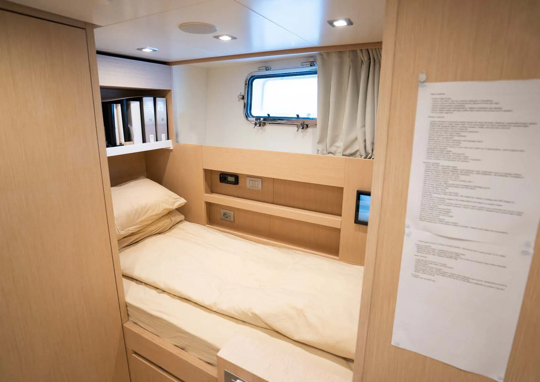 a room with a bed and a bookcase aboard ANMAX Yacht for Sale