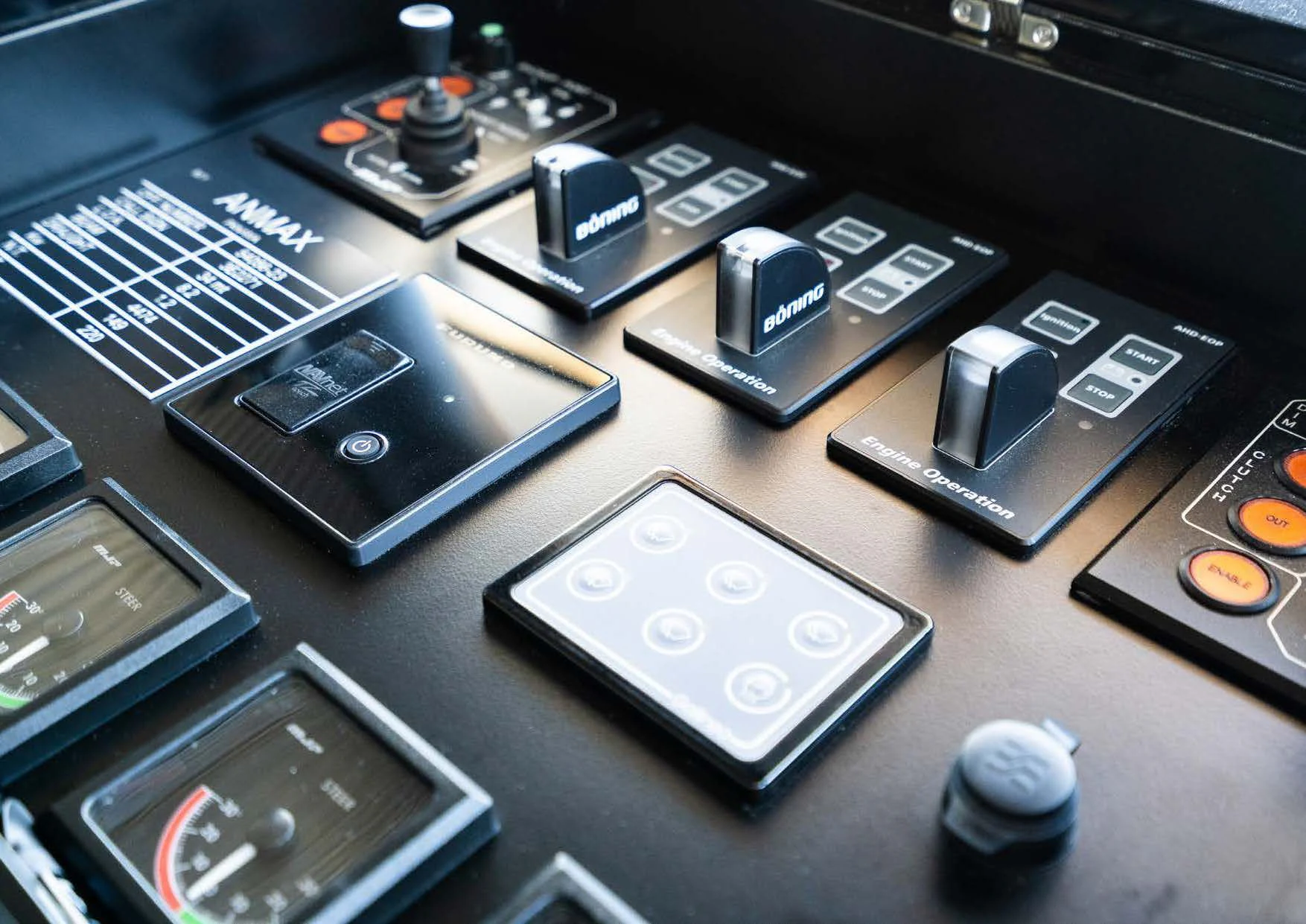 a group of electronic devices on a table aboard ANMAX Yacht for Sale