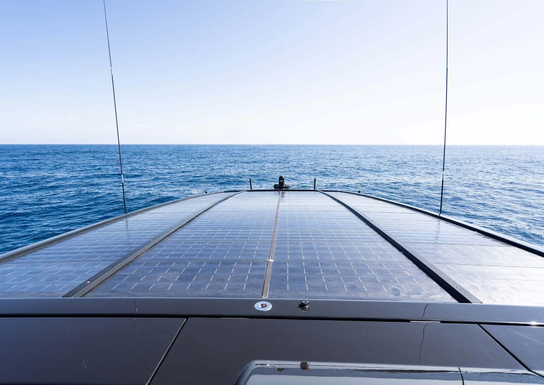 a deck with a view of the ocean and a boat aboard ANMAX Yacht for Sale