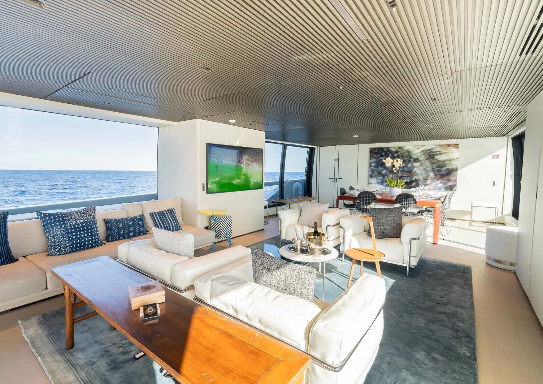 a living room with a large sofa and a large flat screen tv aboard ANMAX Yacht for Sale