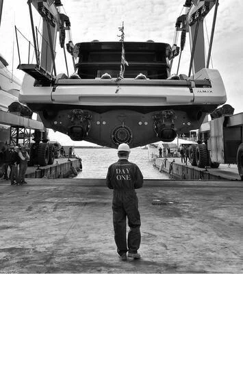 a man standing in front of a military ship aboard ANMAX Yacht for Sale