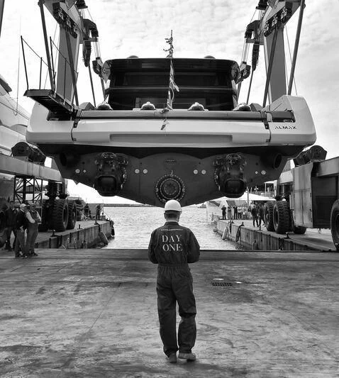 a man standing in front of a large ship aboard ANMAX Yacht for Sale