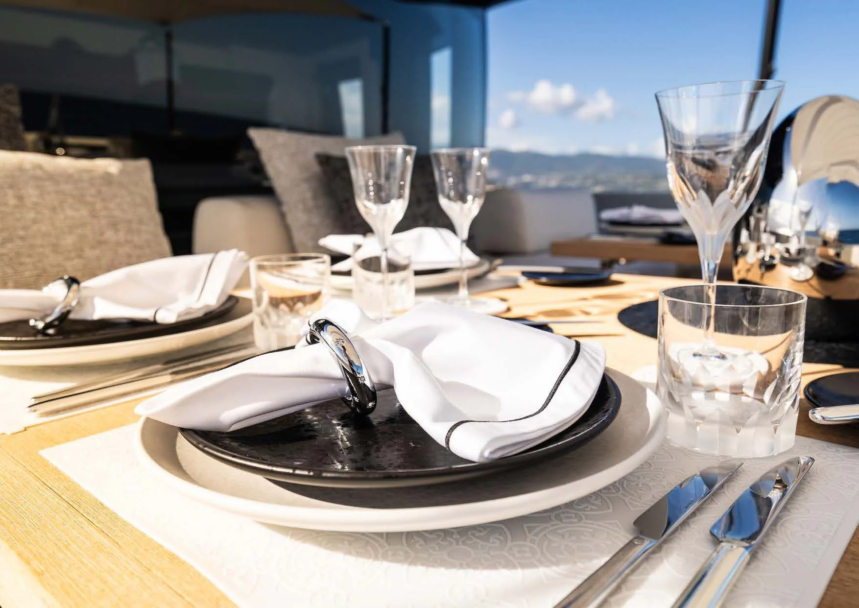 a table with plates and glasses aboard ANMAX Yacht for Sale