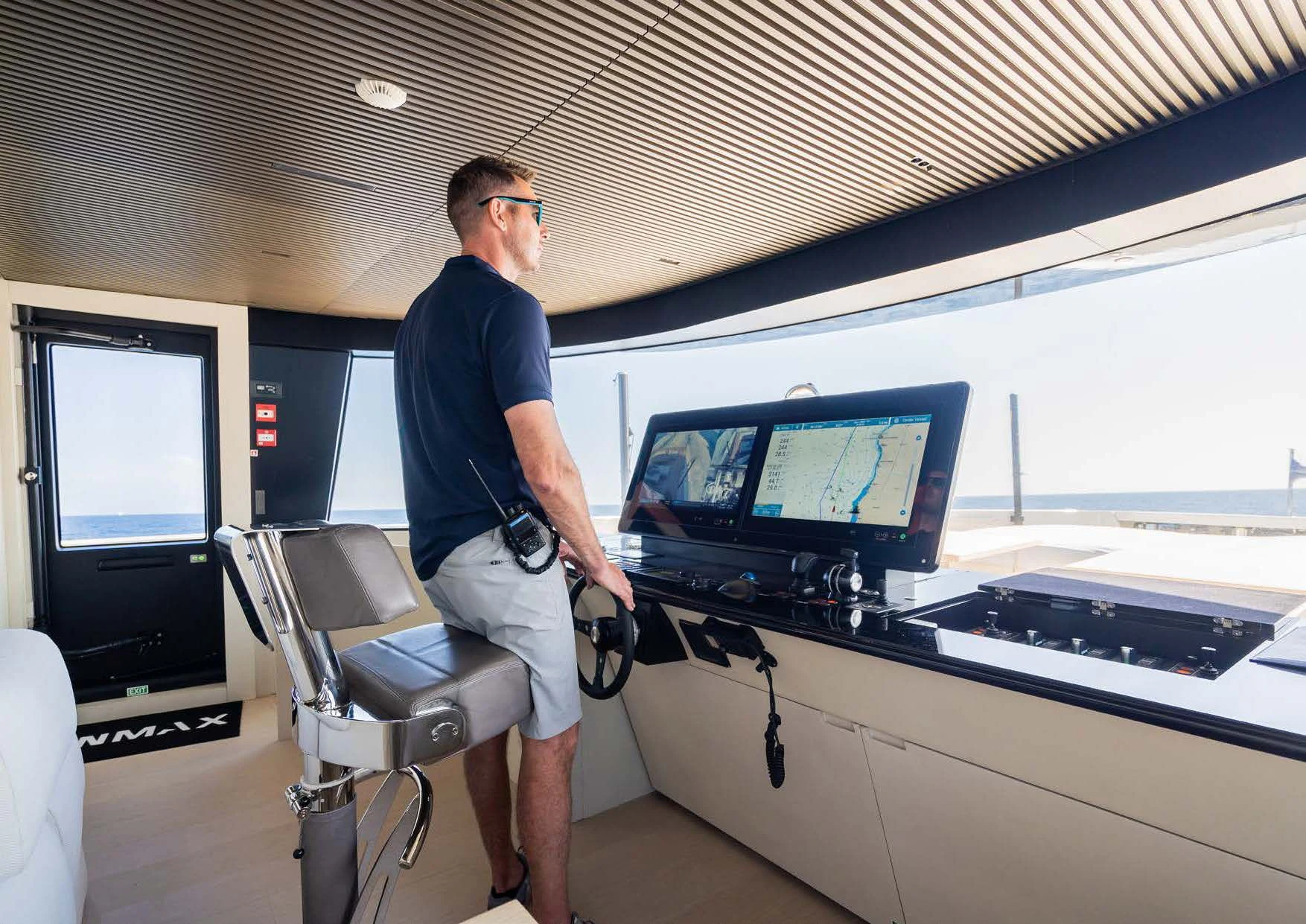a man standing next to a computer aboard ANMAX Yacht for Sale