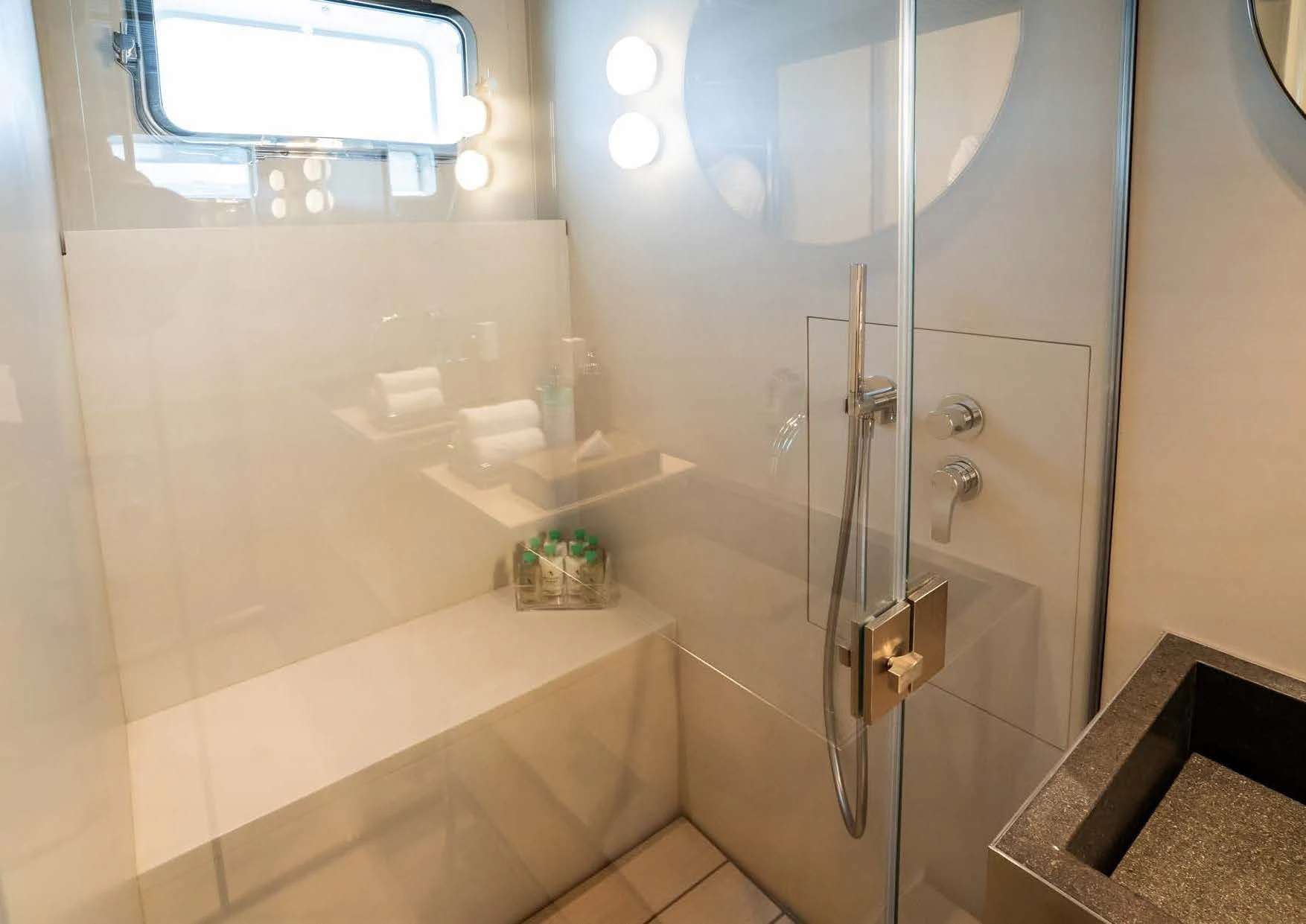 a bathroom with a glass shower aboard ANMAX Yacht for Sale