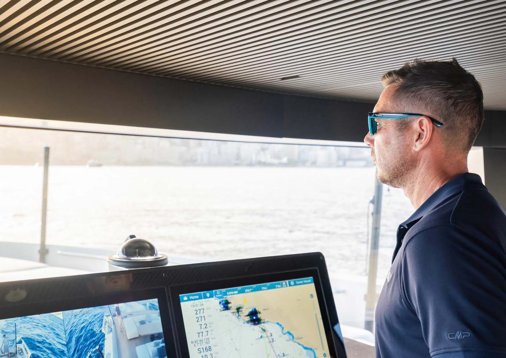 a man looking at a computer screen aboard ANMAX Yacht for Sale