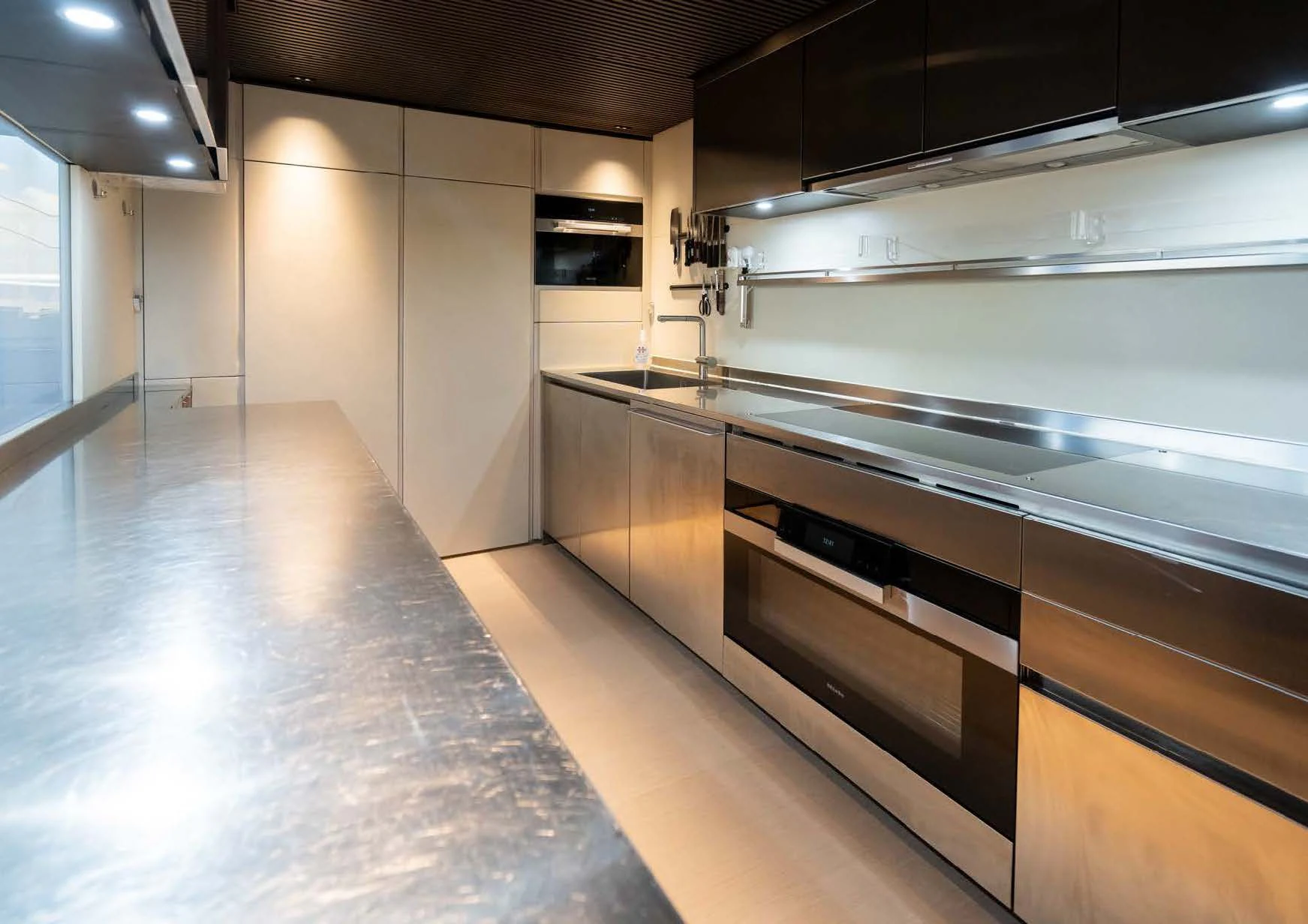 a large kitchen with stainless steel appliances aboard ANMAX Yacht for Sale