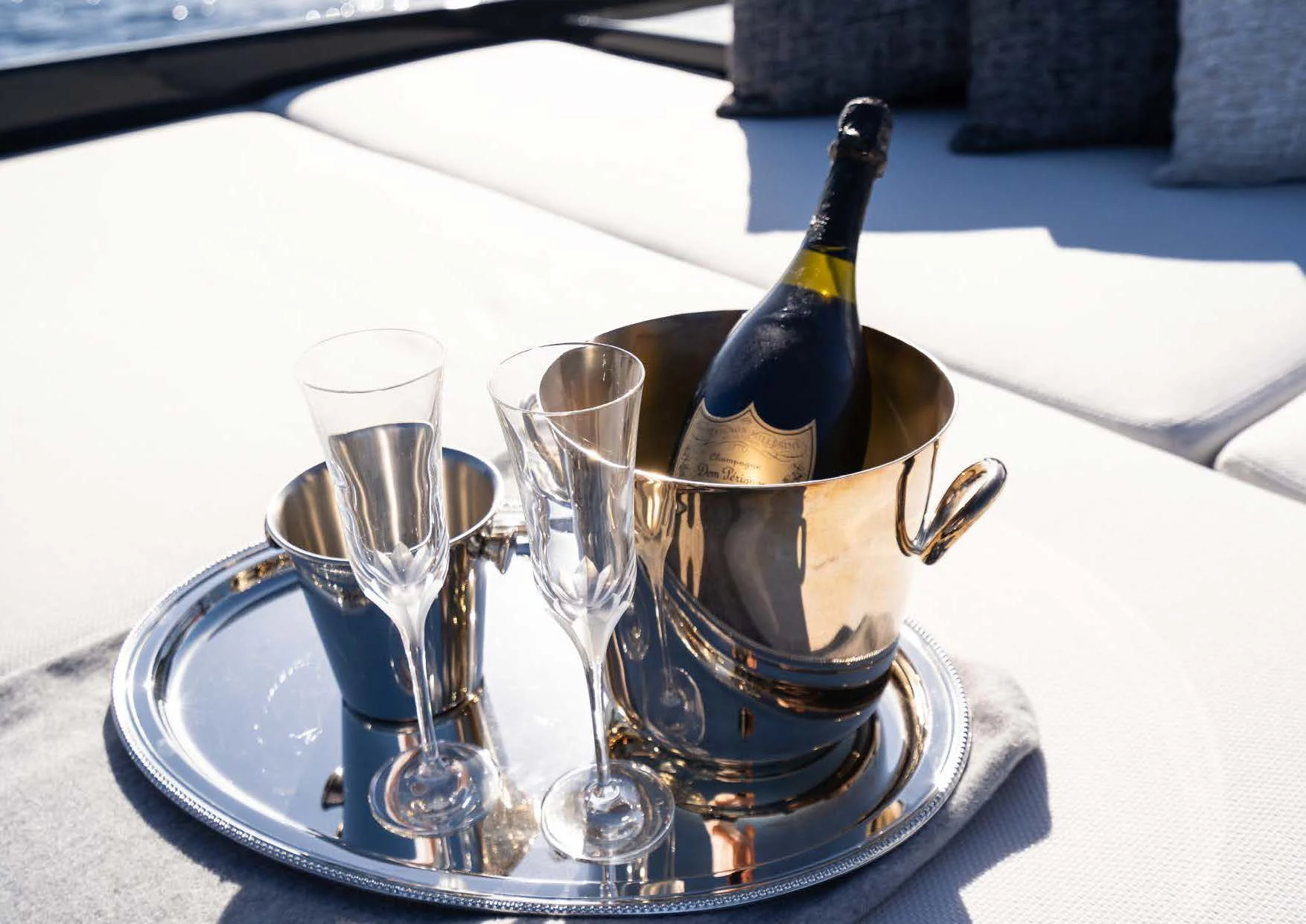 a bottle of champagne on a plate aboard ANMAX Yacht for Sale