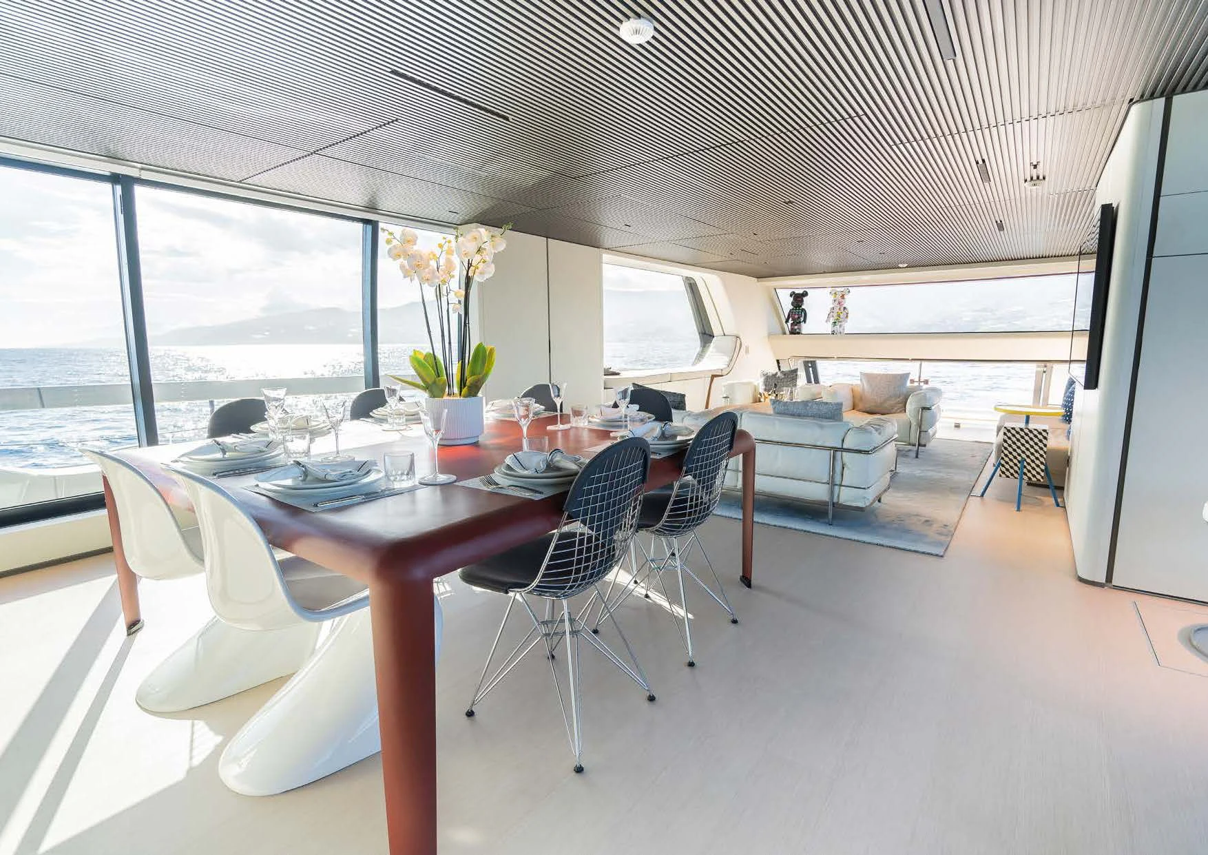 a large room with a table and chairs aboard ANMAX Yacht for Sale