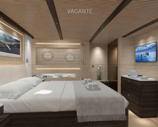 a bedroom with a bed and a tv on the wall aboard VAGANTE Yacht for Sale