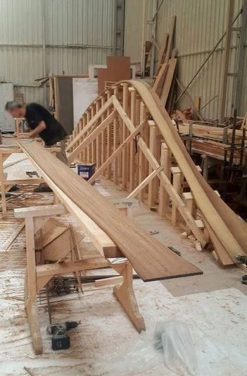 a person working on a wooden structure aboard VAGANTE Yacht for Sale