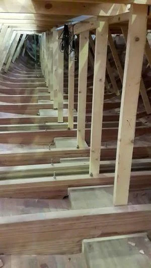 a wooden staircase with a railing aboard VAGANTE Yacht for Sale