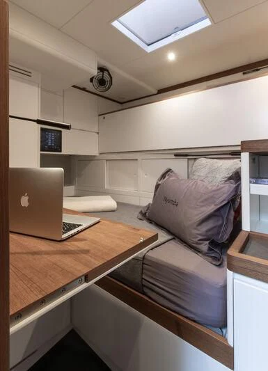 a laptop on a table aboard NYUMBA GT Yacht for Sale