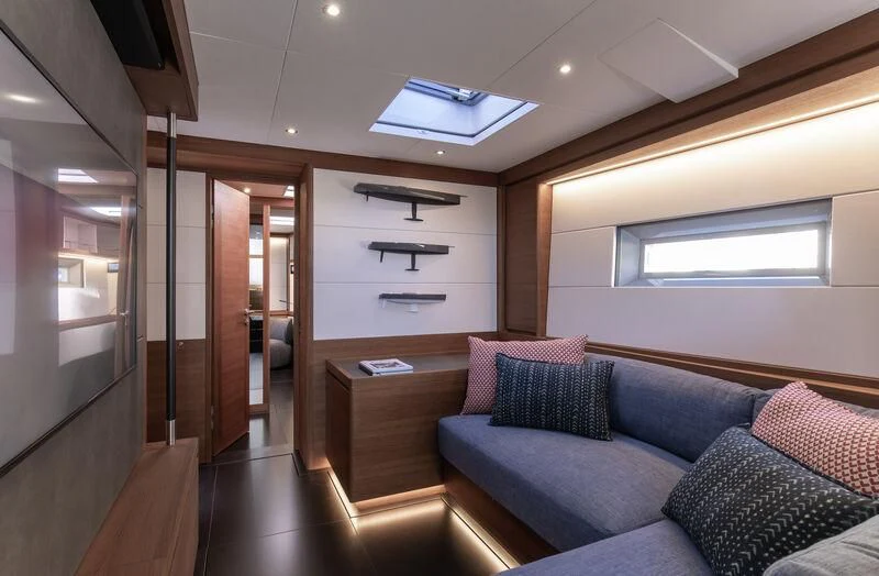 a living room with a couch and a wood door aboard NYUMBA GT Yacht for Sale