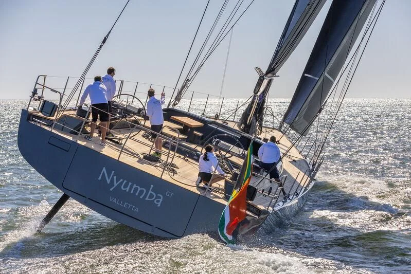 a group of people on a sailboat on the water aboard NYUMBA GT Yacht for Sale